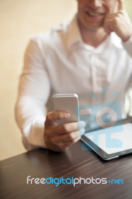 Man With Smartphone In Office Stock Photo