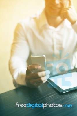 Man With Smartphone In Office Stock Photo