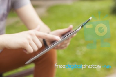 Man With Tablet Reading News And Communicate On Social Networks Stock Photo