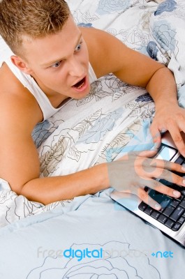 Man Working On Laptop At Home Stock Photo