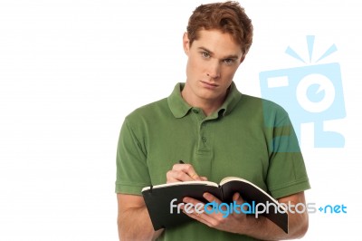 Man Writing On The Notebook Stock Photo