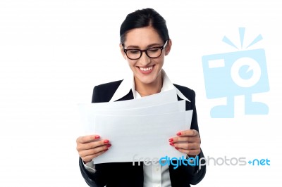 Manager Smilingly Looking At Business Reports Stock Photo