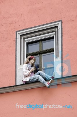 Mannequin Sitting On A Windowledge In Weimar Stock Photo