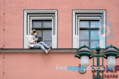 Mannequin Sitting On A Windowledge In Weimar Stock Photo