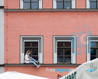 Mannequin Sitting On A Windowledge In Weimar Stock Photo