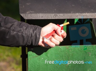 Man's Hand Breaks A Pack Of Cigarettes Stock Photo