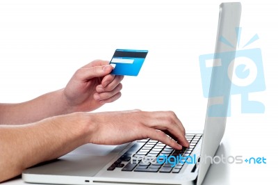 Mans Hand Holding Debit Card And Using Laptop Stock Photo