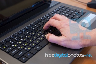 Man's Hand On A Computer Keyboard Stock Photo