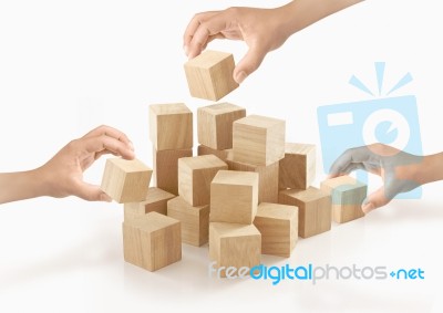 Many Hands Playing Wooden Box On Isolated Background Stock Photo