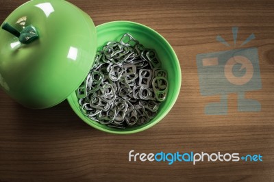 Many Metal Ring Pull In Green Plastic Cup Stock Photo