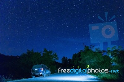 Many Star At The Night Sky With The Car On The Road Stock Photo