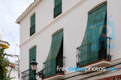 Marbella, Andalucia/spain - July 6 : Green Blinds Over Balconies… Stock Photo