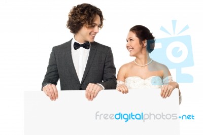 Married Couple Posing With A Blank Ad Board Stock Photo