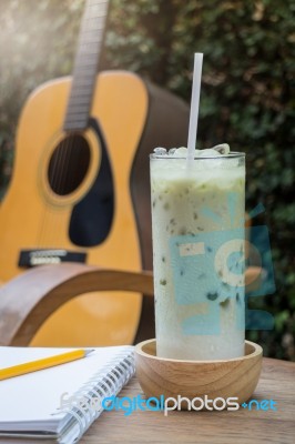 Matcha Tea With Milk On Creative Work Table Stock Photo