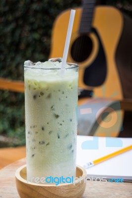 Matcha Tea With Milk On Creative Work Table Stock Photo