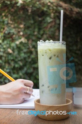 Matcha Tea With Milk On Creative Work Table Stock Photo