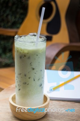 Matcha Tea With Milk On Creative Work Table Stock Photo