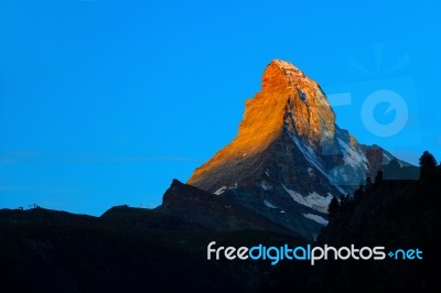 Matterhorn In Early Morning With Alpenglow And Blue Sky In Summe… Stock Photo