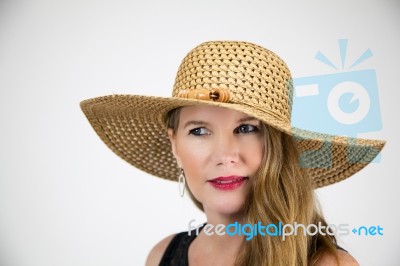 Mature Blonde Female In Large Hat And Black Top Stock Photo