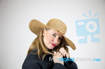 Mature Blonde Female In Large Hat And Coat Stock Photo