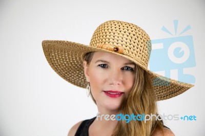 Mature Blonde Female In Large Hat Smiling And Looking At Camera Stock Photo