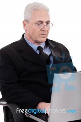 Mature Business Man Busy Working In Notebook Stock Photo