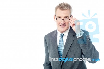 Mature Businessman Holding Eye Wear Stock Photo