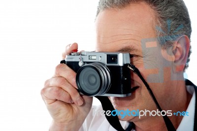 Mature Man Taking Photograph Stock Photo