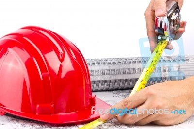 Measuring Hand With Hard Hat Stock Photo