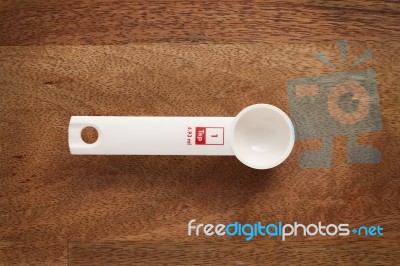 Measuring Spoon On Wooden Background Stock Photo