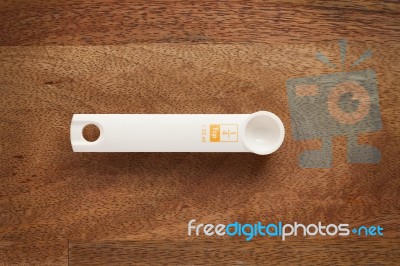 Measuring Spoon On Wooden Background Stock Photo