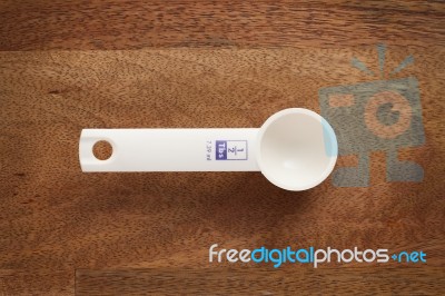 Measuring Spoon On Wooden Background Stock Photo