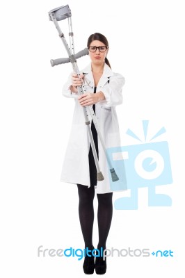 Medical Expert Holding Up The Crutches Stock Photo