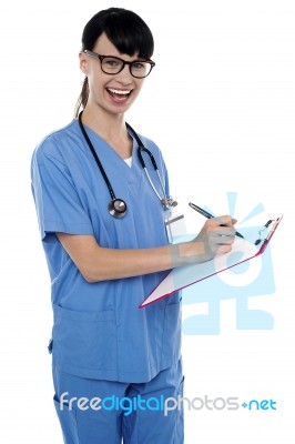 Medical Nurse Jotting Down Notes On Writing Pad Stock Photo