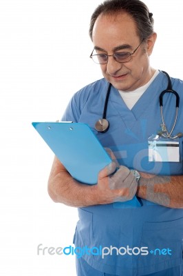 Medical Specialist Studying Report Stock Photo