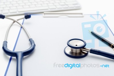 Medical Stethoscope With Clipboard On Table Stock Photo