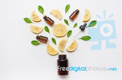 Medicine Bottle With Fresh Lemon Slices And Leaf On White Stock Photo