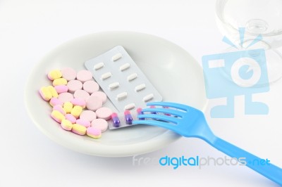 Medicine Tablet Dish With Fork On Table Stock Photo