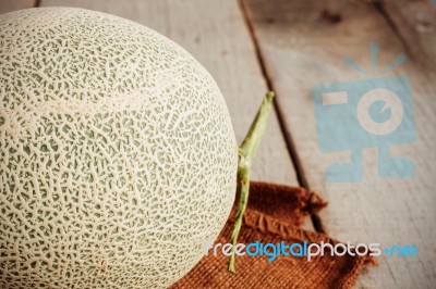 Melon On Wooden Floor Stock Photo