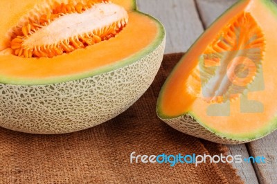 Melon Sliced On Wooden Stock Photo