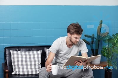 Men Drinking Coffee,reading A Book And Relax In Living Room Stock Photo