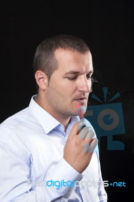 Men Smoke An Electronic Cigarette Stock Photo