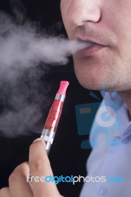 Men Smoke An Electronic Cigarette Stock Photo