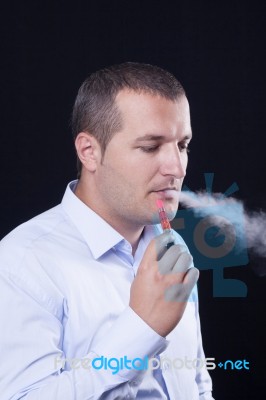 Men Smoke An Electronic Cigarette Stock Photo