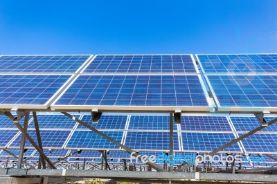 Metal Frames With Rows Of Blue Solar Collectors And Sky Stock Photo