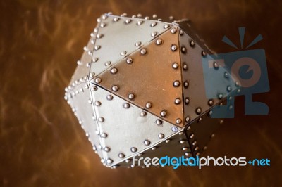 Metal Hexagon Ball On Brown Leather Background Stock Photo