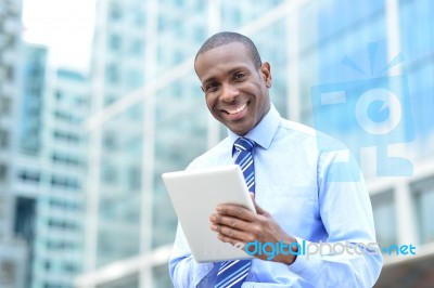 Middle Aged Businessman Using A Tablet Stock Photo