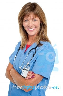 Middle Aged Female Physician With Folded Arms Stock Photo