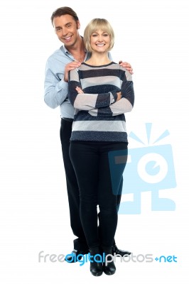 Middle Aged Husband Holding His Wife From Behind Stock Photo