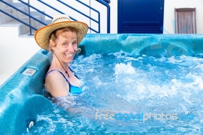 Middle Aged Woman Bathing In Hot Tub Stock Photo